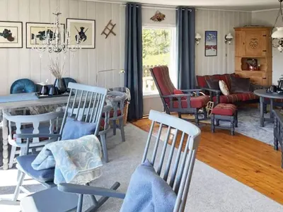 a living room filled with chairs and a table at 4 person holiday home in Svelgen-By Traum in Sørgulen