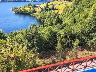 a view of a river with a red bridge at 8 person holiday home in Bruvik-By Traum in Bruvik