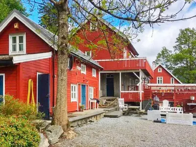 a red home with a red house at 8 person holiday home in Bruvik-By Traum in Bruvik
