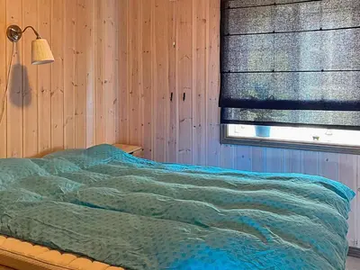 a bedroom with a bed and a window with a blanket at 10 person holiday home in Rauland-By Traum in Rauland
