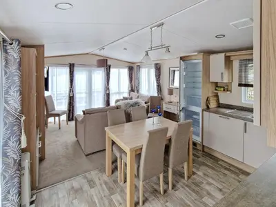 a kitchen and a living room with a table and chairs at 6 person holiday home in Tansøy-By Traum in Tansøy