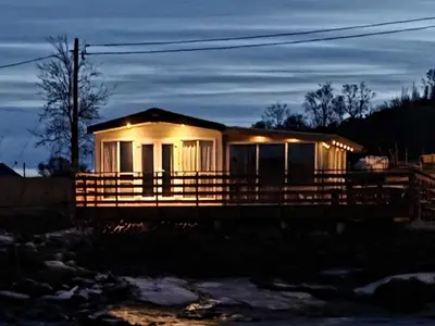 a small house with lights on it at night at 6 person holiday home in Tansøy-By Traum in Tansøy