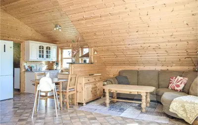 a living room with a couch and a table and a kitchen at Nice Home In Os With House Sea View in Oma