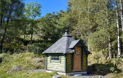 a small house with a tin roof in a field at Nice Home In Os With House Sea View in Oma
