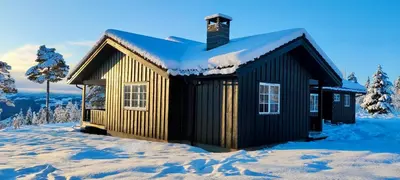 a small cabin in the snow with snow at Nordgards Hagen in Lillehammer