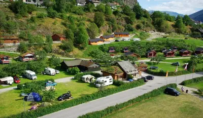 an aerial view of a village with a road and cars at Pluscamp Sandvik in Gaupne