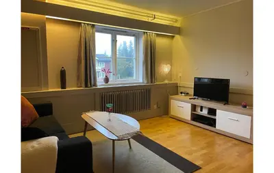 a living room with a couch and a television at Stunning Apartment In Lillehammer in Lillehammer