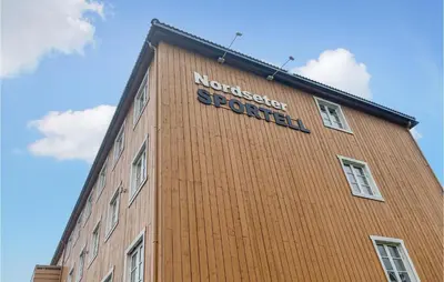 a brown building with a sign on the side of it at Stunning Apartment In Lillehammer in Lillehammer