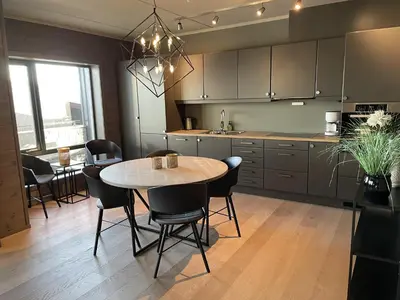a kitchen and dining room with a table and chairs at Riddertunet apartment 101 in Beitostøl