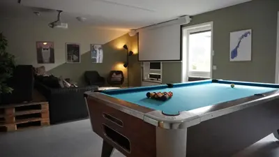 a living room with a pool table in it at Rumi Hostel in Trondheim