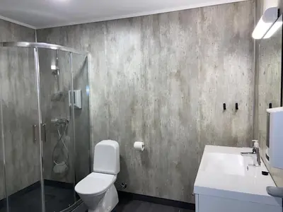 a bathroom with a shower and a toilet and a sink at Brekke Apartments in Flåm