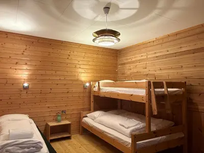 two bunk beds in a room with wooden walls at Brekke Apartments in Flåm