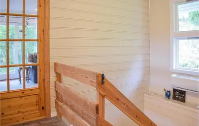 a staircase in a house with wood paneling at 4 Bedroom Lovely Home In Strandebarm in Strandebarm