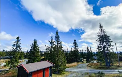 a small red building in a field with trees at 3 Bedroom Stunning Home In Sjusjøen in Sjusjøen