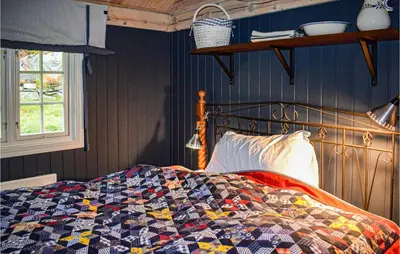 a bed with a quilt on it in a bedroom at 4 Bedroom Pet Friendly Home In Eggedal in Eggedal