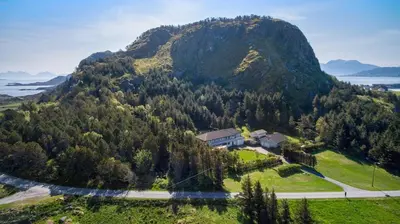 a house on top of a mountain with a road at Flemsøy in Ålesund