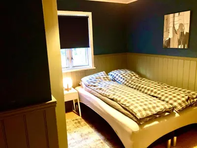a small bedroom with a bed and a window at Flemsøy in Ålesund