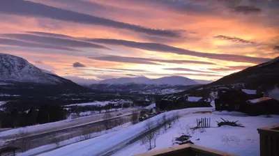 a winter sunset with snow on the ground and mountains at Privat apartment with beautiful view and two bedrooms in Oppdal