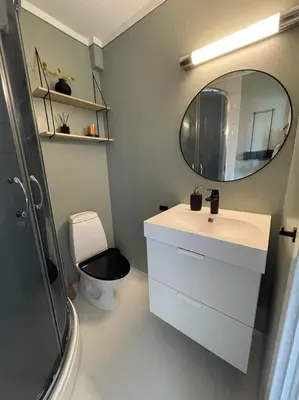 a bathroom with a sink and a mirror and a toilet at Privat apartment with beautiful view and two bedrooms in Oppdal