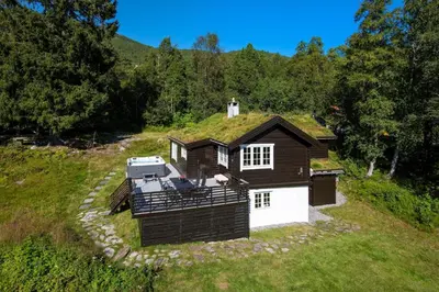 a house with a grass roof on a hill at Økslevegen 2 in Stranda