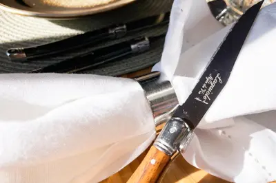 a knife sitting on top of a white napkin at Voss Waterfalls - Norway Mountain Cabin & Traveller Award Winner! in Vossevangen