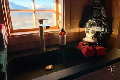 a bathroom sink with a soap dispenser and a window at Voss Waterfalls - Norway Mountain Cabin & Traveller Award Winner! in Vossevangen