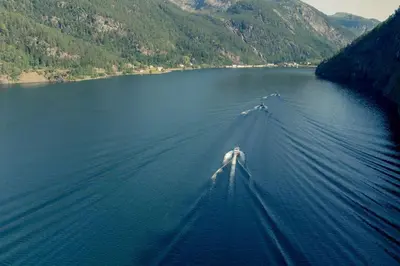 a boat in the middle of a large body of water at Modalen Fjord Cottage in Mo
