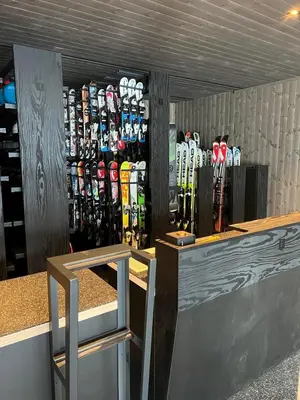 a bunch of skis are lined up on a shelf at Bualie Golsfjellet in Gol