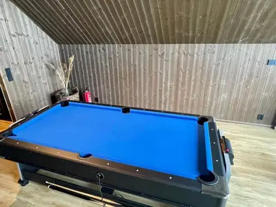 a blue pool table in a room with a wall at 7 person holiday home in Huglo-By Traum in Nordhuglo
