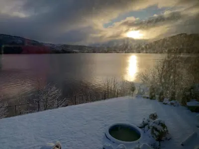 a view of a lake with snow on the ground at Bergen Sunrise Terrace Apartment in Bergen