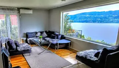 a living room with a view of a large window at Bergen Sunrise Terrace Apartment in Bergen
