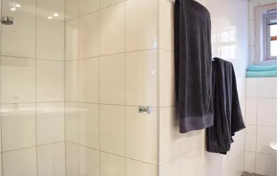 a bathroom with a shower with a glass door at Cozy Home In Norheimsund With Sauna in Norheimsund