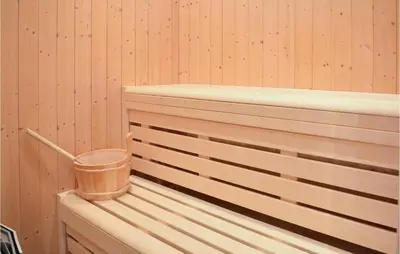 a wooden tub with a bucket on the side of it at Cozy Home In Norheimsund With Sauna in Norheimsund