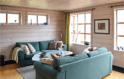 a living room with a couch and a table at Cozy Home In Norheimsund With Sauna in Norheimsund