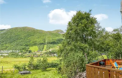 a view of a field with a mountain in the background at 4 Bedroom Cozy Home In Straumgjerde in Brunstad