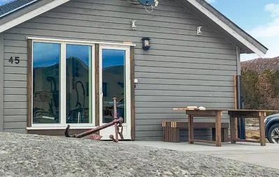 a house with a large window and a picnic table at Pet Friendly Home In Roan in Moen