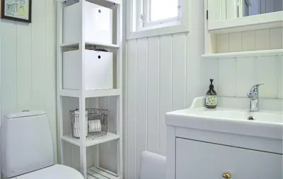 a white bathroom with a sink and a toilet at 1 Bedroom Nice Home In Skånevik in Skånevik