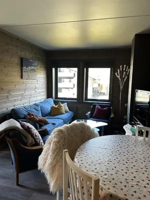 a living room with a blue couch and a table at Kozy apartment in Hemsedal, centrally located in Hemsedal