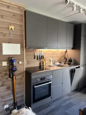a kitchen with white cabinets and a stove top oven at Kozy apartment in Hemsedal, centrally located in Hemsedal