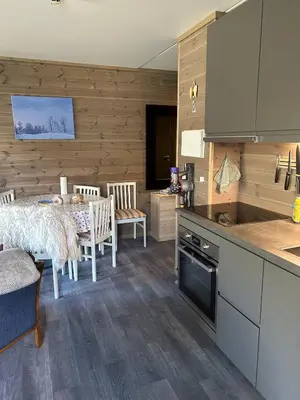 a kitchen and dining room with a table and a counter at Kozy apartment in Hemsedal, centrally located in Hemsedal