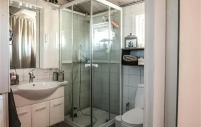 a bathroom with a shower and a sink and a toilet at Stunning Home In Søre Osen in Midskogberget