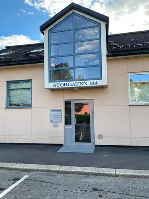 a building with a door and a sign on it at Lovely apartment with parking in the heart of city in Lillehammer