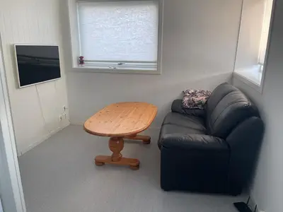 a living room with a couch and a table at Lovely apartment with parking in the heart of city in Lillehammer
