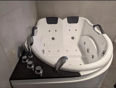 a white bath tub sitting in the corner of a bathroom at Lovely apartment with parking in the heart of city in Lillehammer