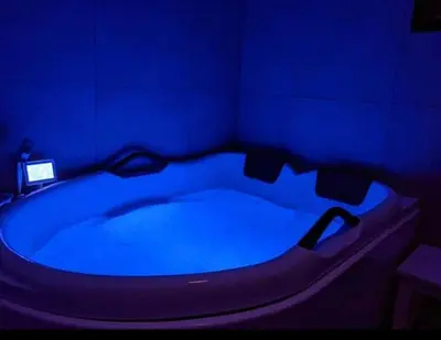 a blue bath tub in a room with a blue floor at Lovely apartment with parking in the heart of city in Lillehammer