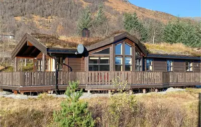 a house with a grass roof on top of it at Cozy Home In Straumgjerde With Sauna in Brunstad