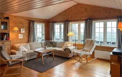 a living room with a couch and a table at Stunning Home In Sjusjøen With Sauna in Sjusjøen