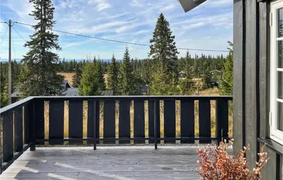 a balcony with a view of the mountains at Stunning Home In Sjusjøen With Sauna in Sjusjøen