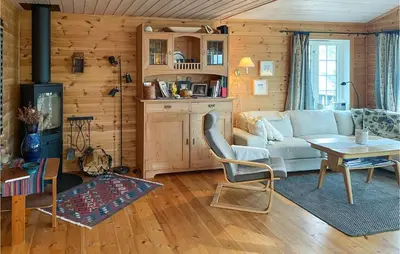 a living room with a couch and a table at Stunning Home In Sjusjøen With Sauna in Sjusjøen