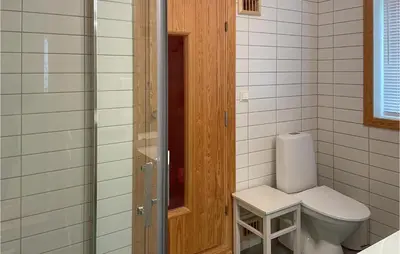 a bathroom with a toilet and a glass shower at Stunning Home In Sjusjøen With Sauna in Sjusjøen